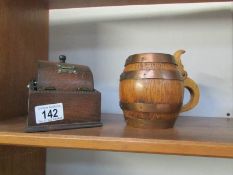 A tobacco jar in the shape of a barrel and an oak cigarette dispenser