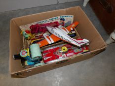 A box of tin plate toys