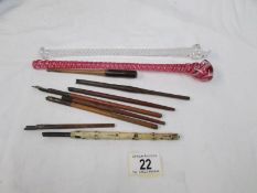 A quantity of old dip pens and 2 twisted glass items