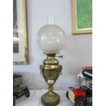 A brass urn shaped oil lamp with etched shade
