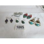 4 pairs of silver earrings and a floral brooch