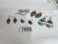 4 pairs of silver earrings and a floral brooch
