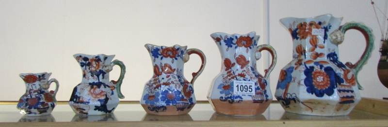 A set of 3 Mason's graduated jugs and 2 other similar Ironstone jugs