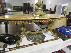 A gilded marble top coffee table