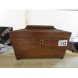 A mahogany sarcophogus tea caddy