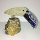 A carved stone pelican with agate beak