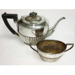 A silver teapot and a silver sugar bowl,