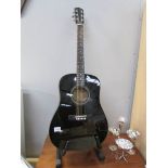 A Fender acoustic guitar and stand