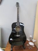 A Fender acoustic guitar and stand