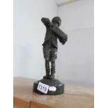 A bronze figure of a boy playing a squeeze box