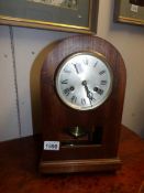 A mahogany bracket clock with cut glass panel and silvered dial