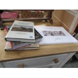 A folio of art prints and 3 art books