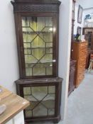 An astragal glazed corner cabinet