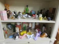 2 shelves of Avon and other perfume bottles