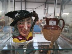 A Doulton Lambeth stone ware jug and a Royal Doulton character jug 'The Pied Piper'