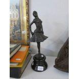 A bronze figure of a dancer