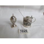 A silver mustard pot, London 1895 and a silver pepperette,