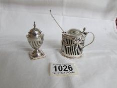 A silver mustard pot, London 1895 and a silver pepperette,