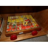 A set of 1960's wooden nursery rhyme jigsaw building blocks in pull along trolley