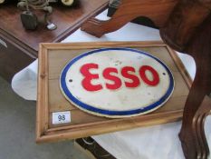 A waxed pine mounted cast iron Esso sign