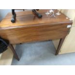 An Edwardian mahogany drop leaf table on tapered legs