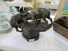 A bronze fighting goats group