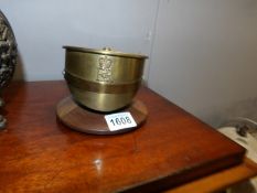 A brass trench art shell case in the shape of a cap
