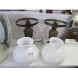 A pair of wall mounted oil lamps with mounts,