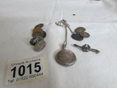 A silver locket, silver cuff links, silver coins etc,