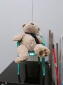 A teddy bear and a child's chair