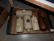 4 stoneware hot water bottles and a copper hot water bottle