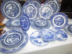 Approximately 26 blue and white plates