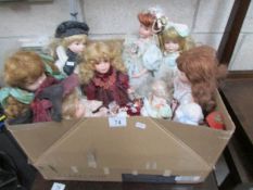 A collection of porcelain headed collector's dolls