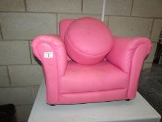 A pink child's chair and stool