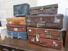 8 vintage suitcases including some with labels