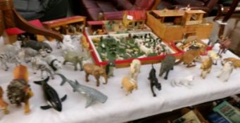 A quantity of children's zoo and farm animals with buildings and fort