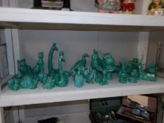 A collection of green glazed pottery animals and figures