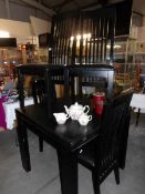 A black dining table and 4 chairs