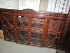 A mahogany astragal glazed break front book case