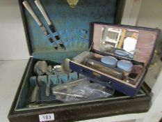 A part canteen of cutlery and a vintage vanity case