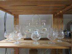 A quantity of cut glass drinking glasses and a 3 bottle tantalus on metal stand
