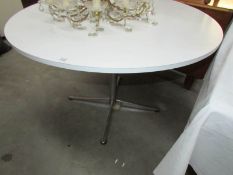 A circular white dining table