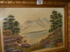 A gilt framed and glazed mountain and lake scene on silk with over stitching,