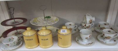 A shelf of china inc. cakestands, storage jars etc.