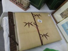 An empty vintage photo album with wood front