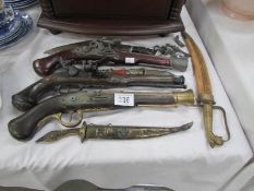 A quantity of replica pistols and daggers etc