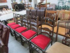 A set of 5 red seated dining chairs