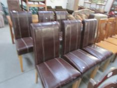 A set of 6 brown leather dining chairs