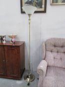 A brushed brass effect uplighter standard lamp