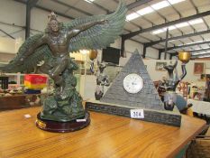 A 'Sphinx' mantel clock and a Juliana winged figure